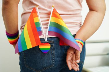 Asian woman with rainbow flag, LGBT symbol rights and gender equality, LGBT Pride Month in June.