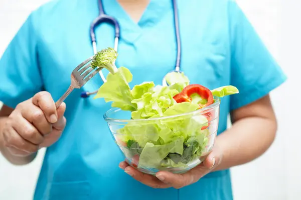 Asian Nutritionist holding healthy food for patient in hospital, nutrition and vitamin.