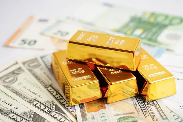 Gold bars with US dollar and Euro banknote money, finance trading investment business currency concept.