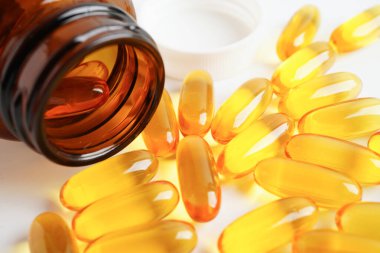 Fish oil or Cod liver oil gel in capsules with omega 3 vitamins, supplementary healthy food 