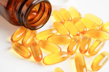 Fish oil or Cod liver oil gel in capsules with omega 3 vitamins, supplementary healthy food 