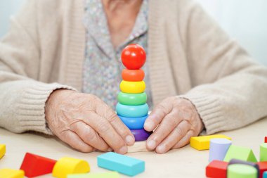 Asyalı yaşlı kadın oyun oynuyor.