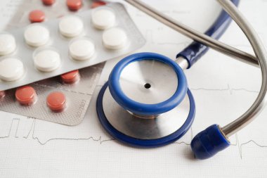 Elektrokardiyogramda stetoskop. Kapsül ilacı, kalp dalgası, kalp krizi, kardiyogram raporu..