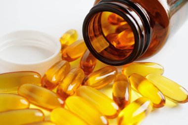 Fish oil or Cod liver oil gel in capsules with omega 3 vitamins, supplementary healthy food 