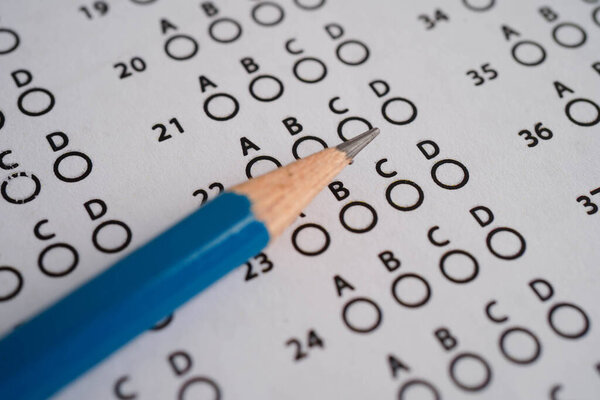 Answer sheets with pencil drawing fill to select choice, education concept.