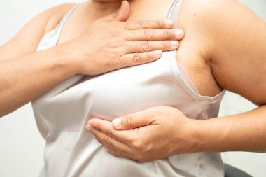 Asyalı kadın kendine dokunuyor çek şişliği ya da göğüs kanseri, göğüs muayenesi.