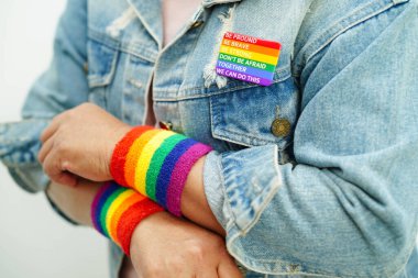 Asian woman with rainbow flag, LGBT symbol rights and gender equality, LGBT Pride Month in June.