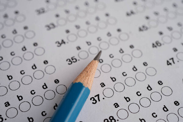 Answer sheets with pencil drawing fill to select choice, education concept.