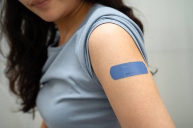 HPV, insan papillomavirus, mavi bandajlı aşı olan Asyalı genç kadın..