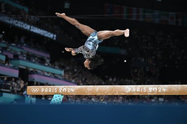 PARIS, FRANCE-July 28: Simone Biles  of team United States competes on the balance beam during the Artistic Gymnastics Women's Qualification at the the Olympic Games Paris 2024 at Bercy Arena on July 28 PARIS, FRANCE clipart