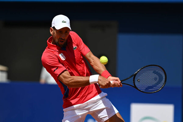 PARIS, FRANCE-July 29:  Novak Djokovic of Team Serbia competes Rafael Nadal during during the Men's Singles second round tennis match on day three of the Olympic Games Paris 2024 at Roland Garros on July 29, 2024 in Paris, France.