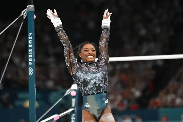 stock image PARIS, FRANCE-July 28: Simone Biles  of USA competes on the unevern bars during the Artistic Gymnastics Women's Qualification at the the Olympic Games Paris 2024 at Bercy Arena