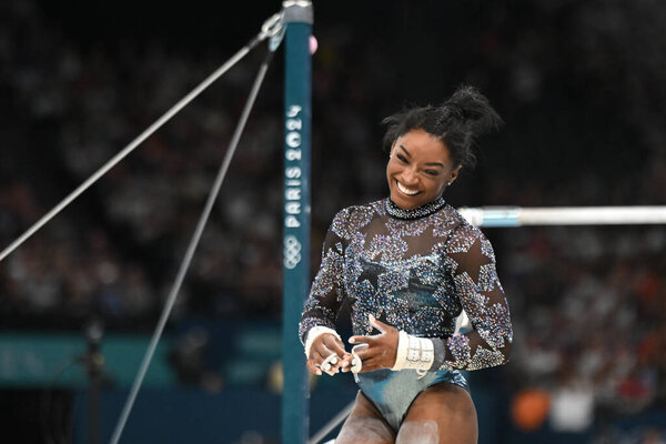 PARIS, FRANCE-July 28: Simone Biles  of USA competes on the unevern bars during the Artistic Gymnastics Women's Qualification at the the Olympic Games Paris 2024 at Bercy Arena