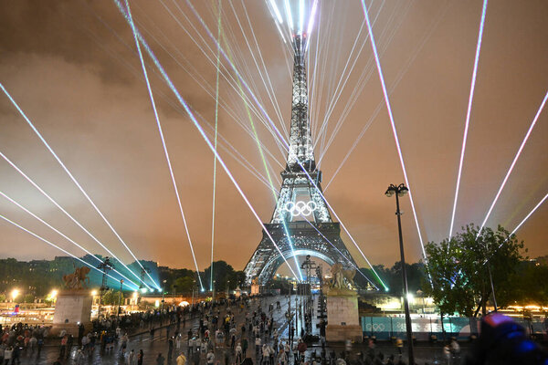 PARIS, FRANCE-26 July 2024: Lights illuminate the Eiffel Tower during the Opening Ceremony of the Olympic Games Paris 2024