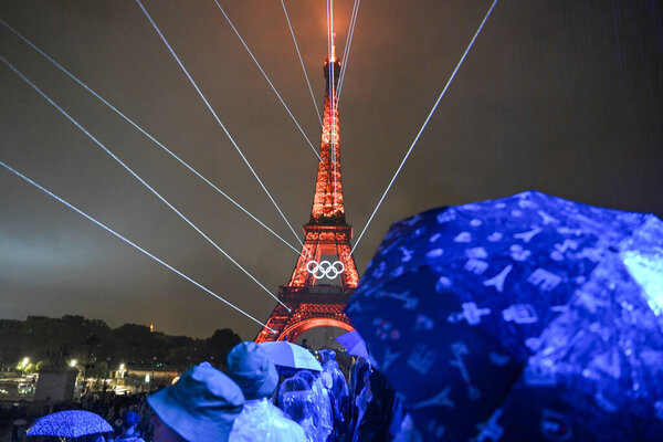 PARIS, FRANCE-26 July 2024: Lights illuminate the Eiffel Tower during the Opening Ceremony of the Olympic Games Paris 2024