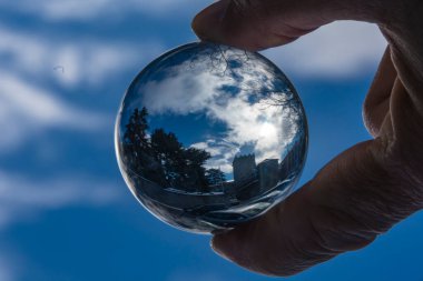 image of a landscape inside a crystal ball held by hand