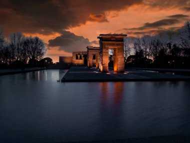 sunset view at the temple of debod in the city of madrid with reflections in the water urban photography