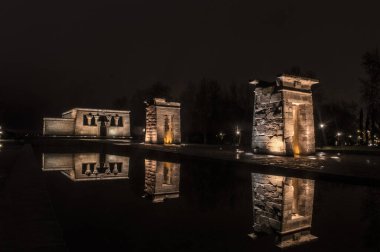 sunset view at the temple of debod in the city of madrid with reflections in the water urban photography