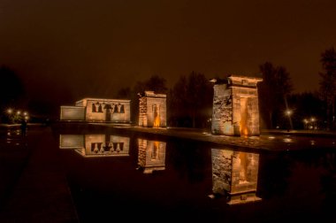 sunset view at the temple of debod in the city of madrid with reflections in the water urban photography