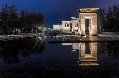 sunset view at the temple of debod in the city of madrid with reflections in the water urban photography