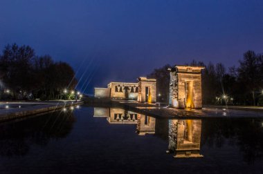 sunset view at the temple of debod in the city of madrid with reflections in the water urban photography