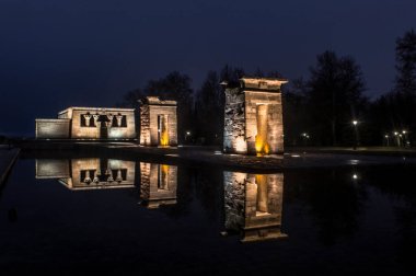 sunset view at the temple of debod in the city of madrid with reflections in the water urban photography