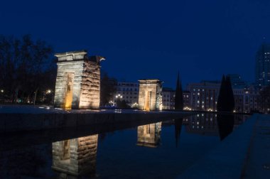 sunset view at the temple of debod in the city of madrid with reflections in the water urban photography