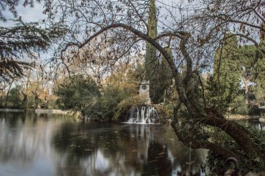 pond with silk water in the fall in the capricho park of the city of madrid urban photography