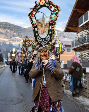 AUSTRIA, GASTEIN - January 1, 2023: Witch and participants in the Perchtenlauf procession in the Austrian Gastein Valley. High quality photo