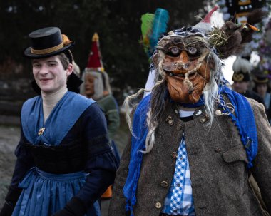 AUSTRIA, GASTEIN - January 1, 2023: Witch with a squirrel on her head in the Perchtenlauf procession in the Austrian Gastein Valley. High quality photo