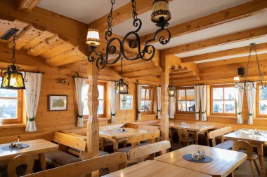 Beautiful design of the mountain restaurant, decorated in the national Austrian style. High quality photo