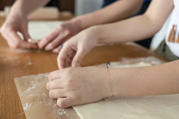 Mother and daughter prepare dough for baking apple pie. High quality photo