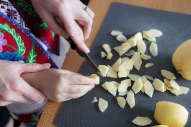 Mother and daughter together cut apples for a pie, the concept of raising children. High quality photo