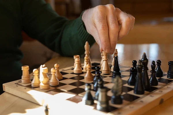Man Sits Wooden Table Makes Chess Move White Piece High — Stock Photo, Image