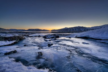 Grundarfjordur, İzlanda 'da güneş doğarken donmuş Kirkjufellsa nehri