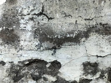 Kirli çatlamış beyaz duvar boyası dökülüyor. Kötü hasar görmüş eski duvar boyası soyuluyor. Boya parçaları kayıp. Çimento soyulmuş grunge duvar dokusundan sıyrılmış..