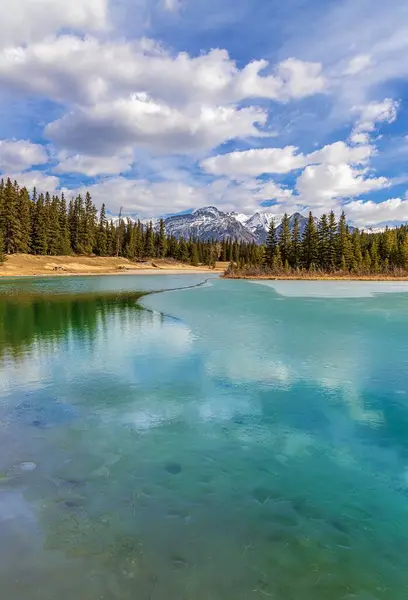 stock image Cloudy Blue Sky Over A Semi Frozen Turquoise Lake