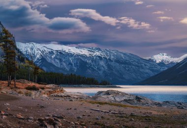 Morning Purple Sky Over Mountains At Lake Minnewanka clipart