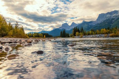 Sunlight Clouds Over Canmore Mountains And River clipart