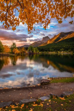 Fall Leaves Framing Quarry Lake Mountains clipart