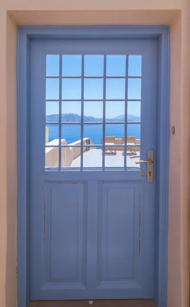 stock image View of the caldera in Santorini through a door.