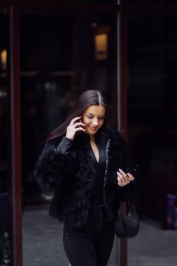 A brown-haired woman wearing black wear