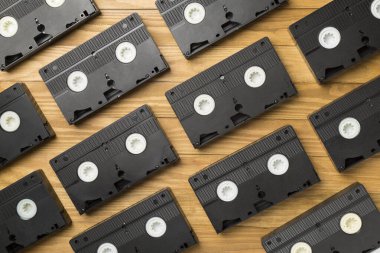 Ahşap zemin üzerinde eski bant VHS kaset deseni, üst görünüm.