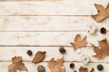 Flat lay composition with autumn leaves on wooden background, top view.