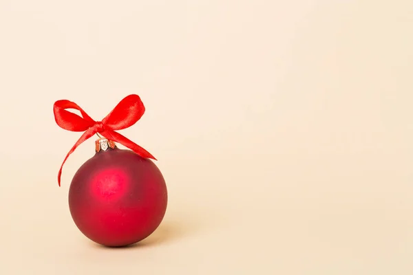 Christmas ball toy on color background.
