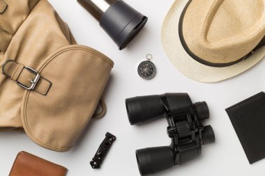 Travel accessories for mountain trip on white background, top view.
