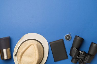 Travel accessories for mountain trip on color background, top view.