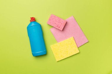 Bulaşık deterjanı ve arka planda süngerli şişe, üst görünüm.