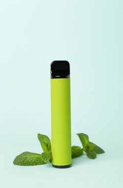 Disposable electronic cigarette and fruit on color background
