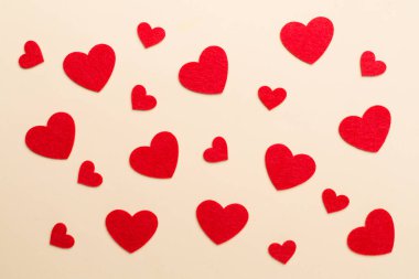 Felt hearts on color background, top view